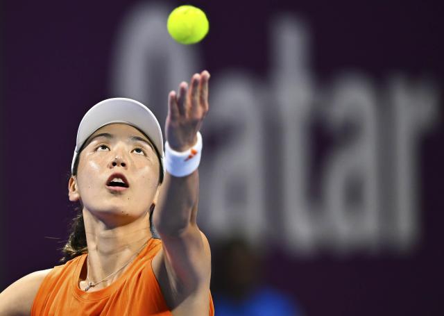 (260211) -- DOHA, Feb. 11, 2026 (Xinhua) -- Wang Xinyu of China serves during the women's singles round of 32 match between Wang Xinyu of China and Elena Rybakina of Kazakhstan at the WTA Qatar Open 2026 tennis tournament in Doha, Qatar, on Feb. 10, 2026. (Photo by Nikku/Xinhua)