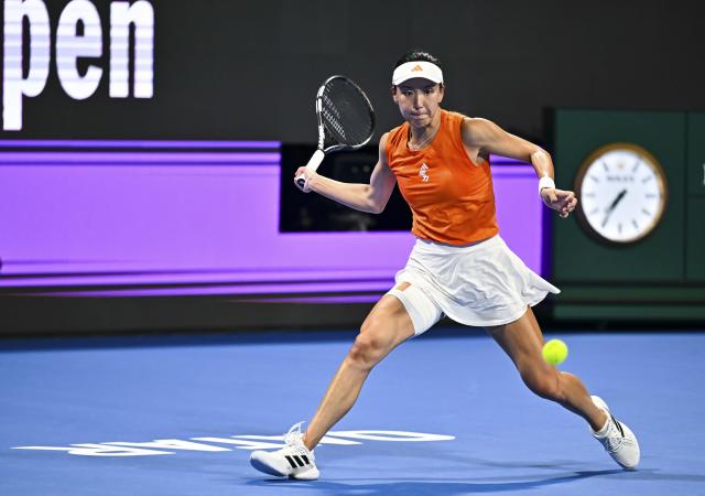 (260211) -- DOHA, Feb. 11, 2026 (Xinhua) -- Wang Xinyu of China hits a return during the women's singles round of 32 match between Wang Xinyu of China and Elena Rybakina of Kazakhstan at the WTA Qatar Open 2026 tennis tournament in Doha, Qatar, on Feb. 10, 2026. (Photo by Nikku/Xinhua)