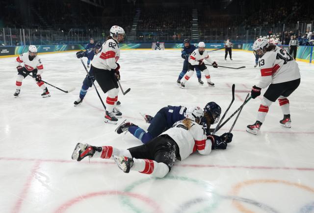 (260211) -- MILAN, Feb. 11, 2026 (Xinhua) -- Sanni Vanhanen (bottom) of Finland vies with Laure Meriguet of Switzerland during the ice hockey women's preliminary round group A match between Finland and Switzerland of the Milan-Cortina 2026 Olympic Winter Games in Milan, Italy, Feb. 10, 2026. (Xinhua/Wang Kaiyan)