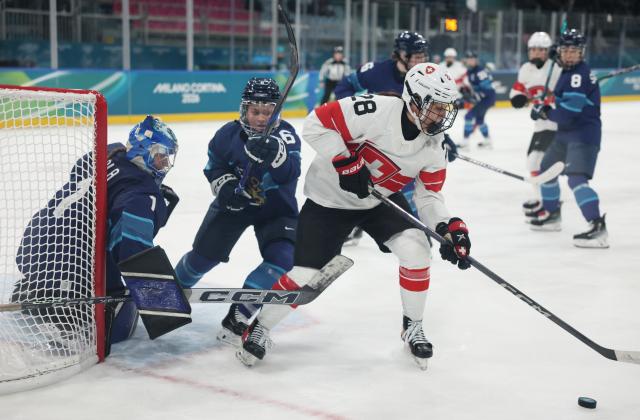 (260211) -- MILAN, Feb. 11, 2026 (Xinhua) -- Switzerland's Alina Marti (R) competes during the ice hockey women's preliminary round group A match between Finland and Switzerland of the Milan-Cortina 2026 Olympic Winter Games in Milan, Italy, Feb. 10, 2026. (Xinhua/Wang Kaiyan)