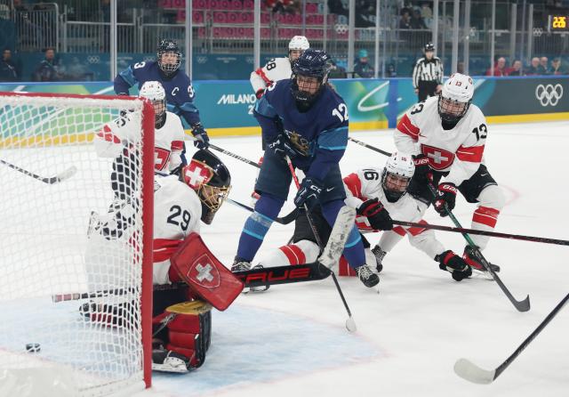 (260211) -- MILAN, Feb. 11, 2026 (Xinhua) -- Switzerland's goalkeeper Saskia Maurer (front L) fails to save a shot during the ice hockey women's preliminary round group A match between Finland and Switzerland of the Milan-Cortina 2026 Olympic Winter Games in Milan, Italy, Feb. 10, 2026. (Xinhua/Wang Kaiyan)