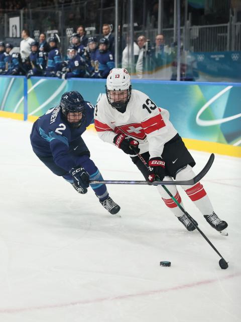 (260211) -- MILAN, Feb. 11, 2026 (Xinhua) -- Switzerland's Ivana Wey (R) breaks through during the ice hockey women's preliminary round group A match between Finland and Switzerland of the Milan-Cortina 2026 Olympic Winter Games in Milan, Italy, Feb. 10, 2026. (Xinhua/Wang Kaiyan)