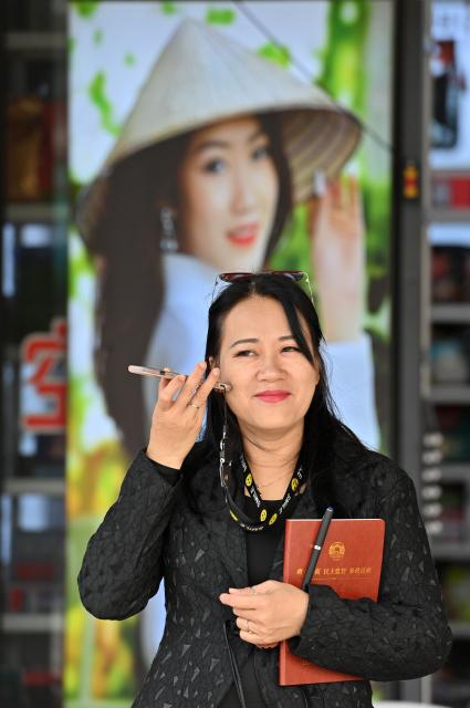 (260211) -- DONGXING, Feb. 11, 2026 (Xinhua) -- Su Haizhen asks for local residents' advice on tourism and cultural development with cellphone near the Dongxing Port in Dongxing City, south China's Guangxi Zhuang Autonomous Region, Feb. 7, 2026. On Jintan Beach in Dongxing City of south China's Guangxi Zhuang Autonomous Region, Su Haizhen plays the Duxianqin, or single-stringed musical instrument, showcasing the unique charm of the Jing ethnic group's special instrument.
   The Jing people are among China's smaller ethnic minority groups, and the only one whose economy is primarily based on marine fishing. They mainly reside in Dongxing City of Guangxi. Duxianqin is a distinctive ethnic instrument of Dongxing's Jing community. With just one string and one lever, it can produce six registers and three octaves. In 2011, the Duxianqin art of Jing people was listed as one of the national intangible cultural heritages in China. 
   Su Haizhen, a Jing native from Dongxing who grew up by the sea, comes from a family that has been dedicated to preserving Jing culture since her grandfather's generation. In 1987, she began formally studying to play the Duxianqin. Today, she is a regional-level representative inheritor of the Duxianqin art of Jing people in the autonomous region. Over nearly four decades of research, inheriting, and development of the instrument, Su has been continuously refining her playing skills while improving the instrument's craftsmanship and exploring innovative performance styles. She is also committed to nurturing more enthusiasts and inheritors of the art.
   In 2023, after becoming a member of the National Committee of the Chinese People's Political Consultative Conference, Su Haizhen felt a stronger sense of mission and responsibility to preserve and promote China's traditional culture. While advocating for Duxianqin education in schools, she has been exploring ways to further highlight the cultural appeal of the art. Leveraging Dongxing's geographical proximity to Vietnam, she aims to foster deeper cultural exchanges and cooperation between China and ASEAN countries like Vietnam. (Xinhua/Lu Boan)