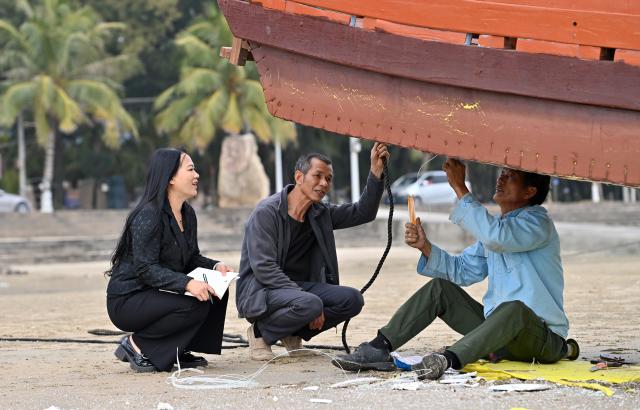 (260211) -- DONGXING, Feb. 11, 2026 (Xinhua) -- Su Haizhen (1st L) asks for fishers' advice on issues concerning people's livelihood and development of traditional culture on Jintan Beach in Dongxing City, south China's Guangxi Zhuang Autonomous Region, Feb. 7, 2026. On Jintan Beach in Dongxing City of south China's Guangxi Zhuang Autonomous Region, Su Haizhen plays the Duxianqin, or single-stringed musical instrument, showcasing the unique charm of the Jing ethnic group's special instrument.
   The Jing people are among China's smaller ethnic minority groups, and the only one whose economy is primarily based on marine fishing. They mainly reside in Dongxing City of Guangxi. Duxianqin is a distinctive ethnic instrument of Dongxing's Jing community. With just one string and one lever, it can produce six registers and three octaves. In 2011, the Duxianqin art of Jing people was listed as one of the national intangible cultural heritages in China. 
   Su Haizhen, a Jing native from Dongxing who grew up by the sea, comes from a family that has been dedicated to preserving Jing culture since her grandfather's generation. In 1987, she began formally studying to play the Duxianqin. Today, she is a regional-level representative inheritor of the Duxianqin art of Jing people in the autonomous region. Over nearly four decades of research, inheriting, and development of the instrument, Su has been continuously refining her playing skills while improving the instrument's craftsmanship and exploring innovative performance styles. She is also committed to nurturing more enthusiasts and inheritors of the art.
   In 2023, after becoming a member of the National Committee of the Chinese People's Political Consultative Conference, Su Haizhen felt a stronger sense of mission and responsibility to preserve and promote China's traditional culture. While advocating for Duxianqin education in schools, she has been exploring ways to further highlight the cultural appeal of the art. Leveraging Dongxing's geographical proximity to Vietnam, she aims to foster deeper cultural exchanges and cooperation between China and ASEAN countries like Vietnam. (Xinhua/Lu Boan)