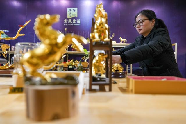 (260211) -- NANJING, Feb. 11, 2026 (Xinhua) -- A staff member arranges horse-themed gold foil products at Jinling Goldfoil Group Co., Ltd. in Nanjing, east China's Jiangsu Province, Feb. 9, 2026. In China, gold foil is widely used as decoration for architectures and also for sculptures, craftworks, food and clothes. 
    Forging gold foil, a traditional craft in Nanjing, has a long history. The making has to go through a dozen of procedures. The gold foil produced here is famous for its pure color and luster, smooth and filmy thickness.
    In 2006, Nanjing's gold foil making technique was inscribed on China's national list of intangible cultural heritage.
    With the approach of the Year of the Horse, the gold foil manufacturers in Nanjing have incorporated elements of the zodiac horse into its designs. (Xinhua/Li Bo)