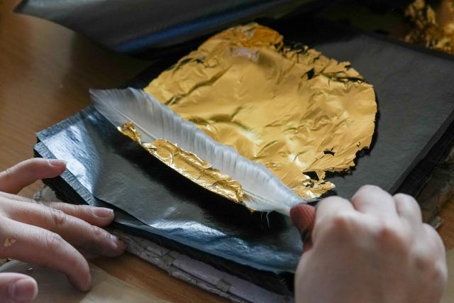 (260211) -- NANJING, Feb. 11, 2026 (Xinhua) -- A worker deals with a piece of gold foil at Jinling Goldfoil Group Co., Ltd. in Nanjing, east China's Jiangsu Province, Feb. 9, 2026. In China, gold foil is widely used as decoration for architectures and also for sculptures, craftworks, food and clothes. 
    Forging gold foil, a traditional craft in Nanjing, has a long history. The making has to go through a dozen of procedures. The gold foil produced here is famous for its pure color and luster, smooth and filmy thickness.
    In 2006, Nanjing's gold foil making technique was inscribed on China's national list of intangible cultural heritage.
    With the approach of the Year of the Horse, the gold foil manufacturers in Nanjing have incorporated elements of the zodiac horse into its designs. (Xinhua/Li Bo)