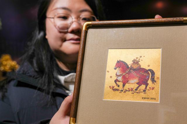 (260211) -- NANJING, Feb. 11, 2026 (Xinhua) -- A staff member presents a horse-themed gold foil product at Jinling Goldfoil Group Co., Ltd. in Nanjing, east China's Jiangsu Province, Feb. 9, 2026. In China, gold foil is widely used as decoration for architectures and also for sculptures, craftworks, food and clothes. 
    Forging gold foil, a traditional craft in Nanjing, has a long history. The making has to go through a dozen of procedures. The gold foil produced here is famous for its pure color and luster, smooth and filmy thickness.
    In 2006, Nanjing's gold foil making technique was inscribed on China's national list of intangible cultural heritage.
    With the approach of the Year of the Horse, the gold foil manufacturers in Nanjing have incorporated elements of the zodiac horse into its designs. (Xinhua/Li Bo)
