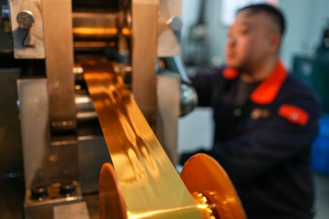 (260211) -- NANJING, Feb. 11, 2026 (Xinhua) -- A worker operates a gold processing machine at Jinling Goldfoil Group Co., Ltd. in Nanjing, east China's Jiangsu Province, Feb. 10, 2026. In China, gold foil is widely used as decoration for architectures and also for sculptures, craftworks, food and clothes. 
    Forging gold foil, a traditional craft in Nanjing, has a long history. The making has to go through a dozen of procedures. The gold foil produced here is famous for its pure color and luster, smooth and filmy thickness.
    In 2006, Nanjing's gold foil making technique was inscribed on China's national list of intangible cultural heritage.
    With the approach of the Year of the Horse, the gold foil manufacturers in Nanjing have incorporated elements of the zodiac horse into its designs. (Xinhua/Li Bo)