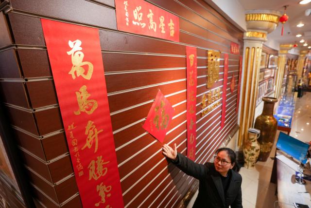 (260211) -- NANJING, Feb. 11, 2026 (Xinhua) -- A staff member presents gold foil couplets products at Jinling Goldfoil Group Co., Ltd. in Nanjing, east China's Jiangsu Province, Feb. 9, 2026. In China, gold foil is widely used as decoration for architectures and also for sculptures, craftworks, food and clothes. 
    Forging gold foil, a traditional craft in Nanjing, has a long history. The making has to go through a dozen of procedures. The gold foil produced here is famous for its pure color and luster, smooth and filmy thickness.
    In 2006, Nanjing's gold foil making technique was inscribed on China's national list of intangible cultural heritage.
    With the approach of the Year of the Horse, the gold foil manufacturers in Nanjing have incorporated elements of the zodiac horse into its designs. (Xinhua/Li Bo)