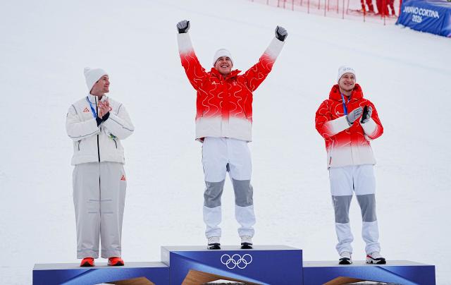 (260211) -- BORMIO, Feb. 11, 2026 (Xinhua) -- Gold medalist Franjo von Allmen (C) of Switzerland, silver medalist Ryan Cochran-Siegle (L) of the United States and bronze medalist Marco Odermatt of Switzerland react during the awarding ceremony for the alpine skiing men's Super-G at the Milan-Cortina 2026 Olympic Winter Games in Bormio, Italy, Feb. 11, 2026. (Xinhua/Yan Linyun)