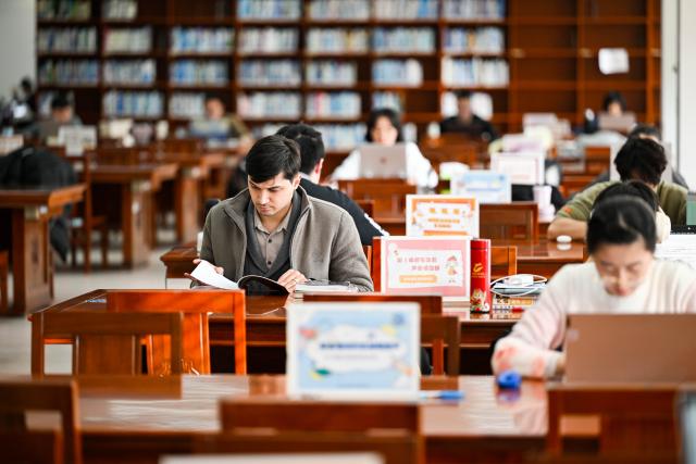(260211) -- TIANJIN, Feb. 11, 2026 (Xinhua) -- Suleimanov Umar reads at the library in Nankai University, north China's Tianjin, Feb. 5, 2026. On the occasion of traditional Chinese Xiaonian Festival in northern China, which fell on Tuesday this year, Suleimanov Umar, a 26-year-old Tajikistan student in Nankai University of Tianjin, and other international students visited a local festive fair in Chuanfangyu Town to experience the vibrant traditions of Chinese New Year. Celebrated on the 23rd day of the last month of the Chinese lunar calendar, Xiaonian is a festival marking the start of the countdown to the Chinese New Year.
   When Suleimanov was a child, most neighbors were Chinese working in Tajikistan, thus he was deeply impressed by Chinese New Year traditions such as putting up Spring Festival couplets and making dumplings.
   When in middle school, he began studying Chinese at local Confucius Institute, and then chose to go to university in China with the support of his family. While staying in China he immersed himself in social practice and actively participated in cultural exchange activities.
    Speaking of the future, Suleimanov said, "I hope I could engage in diplomatic work after graduation and strive to become an envoy of friendship". (Xinhua/Zhao Zishuo)