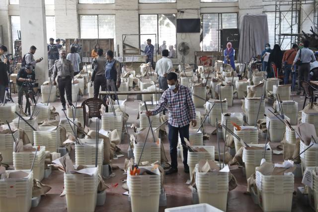 (260211) -- DHAKA, Feb. 11, 2026 (Xinhua) -- Staff members check ballot boxes ahead of the general election in Dhaka, Bangladesh, Feb. 11, 2026. Bangladesh is all set for Thursday's general elections in which more than 127 million voters are expected to cast their ballots at over 42,000 polling stations across the country, a senior official said Tuesday. (Photo by Habibur Rahman/Xinhua)