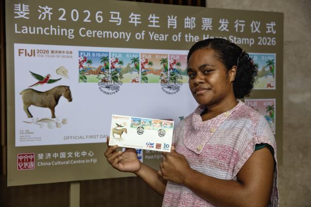 (260211) -- SUVA, Feb. 11, 2026 (Xinhua) -- A woman shows an official first day cover with the newly-issued Year of the Horse stamps in Suva, Fiji, Feb. 10, 2026. Post Fiji and the China Cultural Center in Fiji jointly issued a set of commemorative stamps marking the upcoming Chinese New Year of the Horse in the capital city of Suva on Tuesday evening. (Photo by Chen Peng/Xinhua)