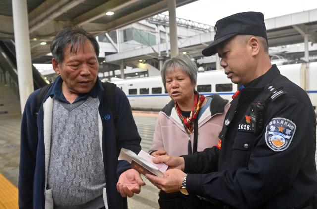 (260211) -- NANNING, Feb. 11, 2026 (Xinhua) -- Huang Qingming checks passengers' IDs at a platform of the Nanning Railway Station in Nanning, south China's Guangxi Zhuang Autonomous Region, Feb. 10, 2026. The China-Vietnam international passenger rail service, which resumed operations on May 25, 2025, is now facing its first Spring Festival travel rush. Huang Qingming, a 58-year-old railway police officer, has been working on this route since 2012, responsible for the Nanning-Pingxiang section of trains No. T8701 and No. T8702 in Guangxi. 
   As a railway police officer, handling various emergencies, conducting train's security check and ensuring passenger safety during the journey are part of Huang's daily routine.
   Approaching retirement, Huang cherishes his role deeply, "Serving as a railway police officer on the China-Vietnam international passenger rail service, safeguarding the trains' security and passengers' safety, has been an honorable and unforgettable experience in my career." (Xinhua/Lu Boan)