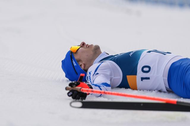 (260211) -- TESERO, Feb. 11, 2026 (Xinhua) -- Eero Hirvonen of Finland lies on the snow after the Cross-Country competition of Nordic Combined Individual Gundersen Normal Hill/10km at the Milan-Cortina 2026 Olympic Winter Games in Tesero, Italy, Feb. 11, 2026. (Xinhua/Peng Ziyang)