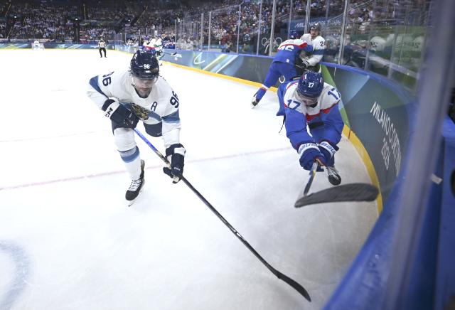 (260211) -- MILAN, Feb. 11, 2026 (Xinhua) -- Mikko Rantanen (L) of Finland vies with Simon Nemec of Slovakia during the ice hockey men's preliminary round group B match between Finland and Slovakia at the Milan-Cortina 2026 Olympic Winter Games in Milan, Italy, Feb. 11, 2026. (Xinhua/Zhang Haofu)