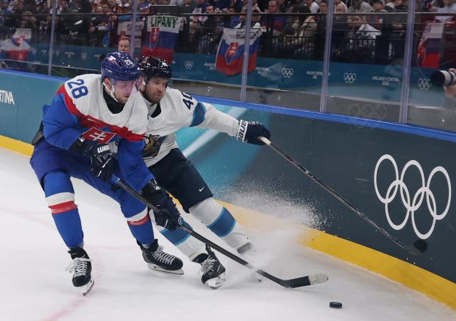 (260211) -- MILAN, Feb. 11, 2026 (Xinhua) -- Joel Armia (R) of Finland vies with Martin Gernat of Slovakia during the ice hockey men's preliminary round group B match between Finland and Slovakia at the Milan-Cortina 2026 Olympic Winter Games in Milan, Italy, Feb. 11, 2026. (Xinhua/Wang Kaiyan)