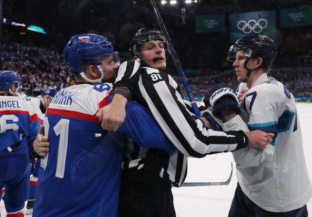 (260211) -- MILAN, Feb. 11, 2026 (Xinhua) -- Niko Mikkola (R) of Finland and Erik Cernak of Slovakia fight during the ice hockey men's preliminary round group B match between Finland and Slovakia at the Milan-Cortina 2026 Olympic Winter Games in Milan, Italy, Feb. 11, 2026. (Xinhua/Wang Kaiyan)