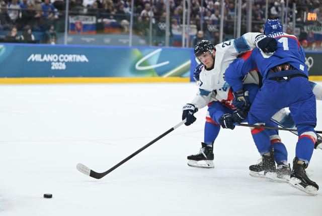 (260211) -- MILAN, Feb. 11, 2026 (Xinhua) -- Eetu Luostarinen (C) of Finland breaks through during the ice hockey men's preliminary round group B match between Finland and Slovakia at the Milan-Cortina 2026 Olympic Winter Games in Milan, Italy, Feb. 11, 2026. (Xinhua/Zhang Haofu)