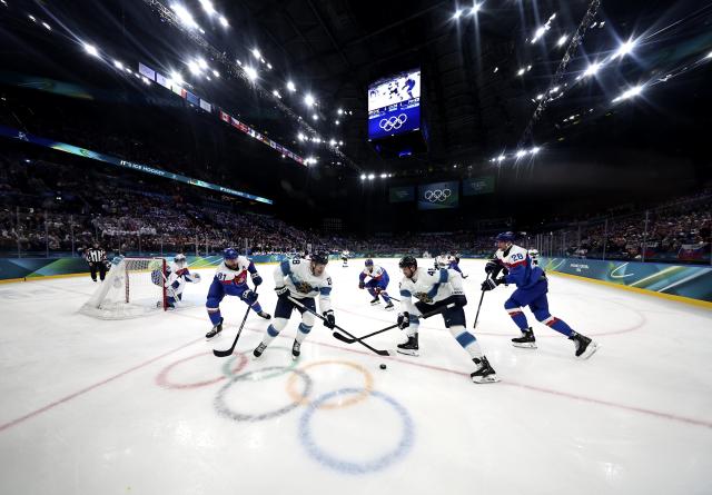(260211) -- MILAN, Feb. 11, 2026 (Xinhua) -- Eeli Tolvanen (L, front) of Finland competes during the ice hockey men's preliminary round group B match between Finland and Slovakia at the Milan-Cortina 2026 Olympic Winter Games in Milan, Italy, Feb. 11, 2026. (Xinhua/Wang Kaiyan)