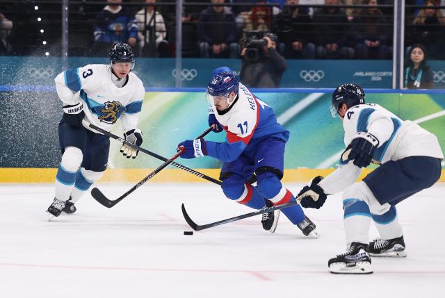 (260211) -- MILAN, Feb. 11, 2026 (Xinhua) -- Milos Kelemen (C) of Slovakia breaks through during the ice hockey men's preliminary round group B match between Finland and Slovakia at the Milan-Cortina 2026 Olympic Winter Games in Milan, Italy, Feb. 11, 2026. (Xinhua/Wang Kaiyan)