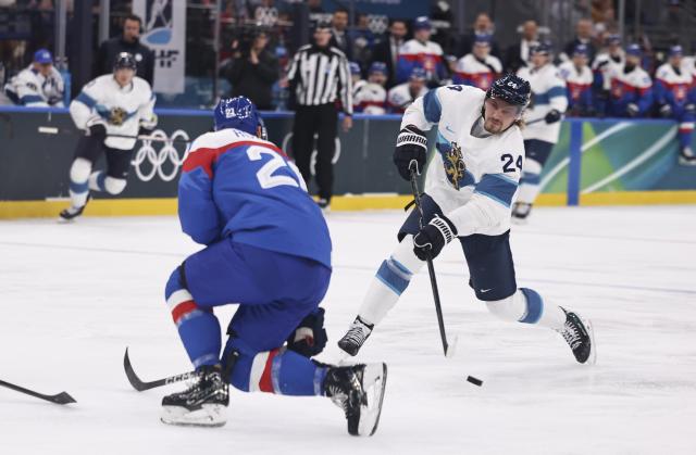 (260211) -- MILAN, Feb. 11, 2026 (Xinhua) -- Roope Hintz (R) of Finland shoots during the ice hockey men's preliminary round group B match between Finland and Slovakia at the Milan-Cortina 2026 Olympic Winter Games in Milan, Italy, Feb. 11, 2026. (Xinhua/Wang Kaiyan)