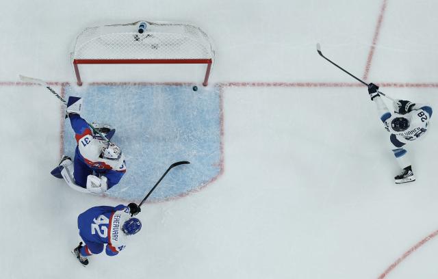 (260211) -- MILAN, Feb. 11, 2026 (Xinhua) -- Eeli Tolvanen (R) of Finland shoots to score during the ice hockey men's preliminary round group B match between Finland and Slovakia at the Milan-Cortina 2026 Olympic Winter Games in Milan, Italy, Feb. 11, 2026. (Xinhua/Zhang Haofu)