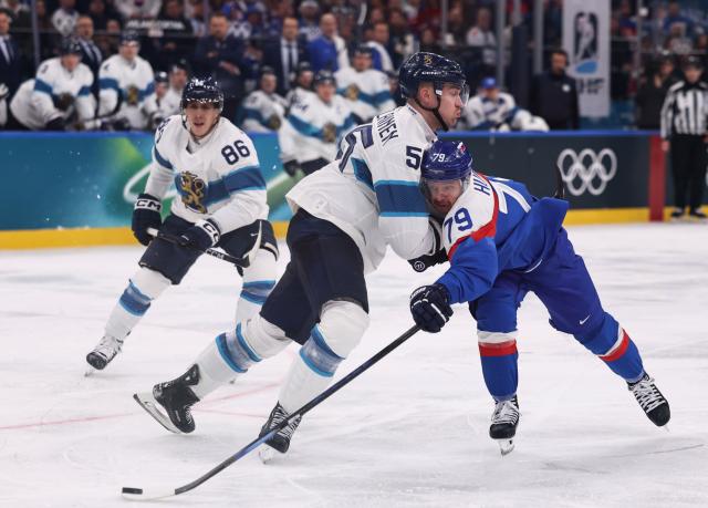 (260211) -- MILAN, Feb. 11, 2026 (Xinhua) -- Rusmus Ristolainen of Finland (C) defends during the ice hockey men's preliminary round group B match between Finland and Slovakia at the Milan-Cortina 2026 Olympic Winter Games in Milan, Italy, Feb. 11, 2026. (Xinhua/Wang Kaiyan)