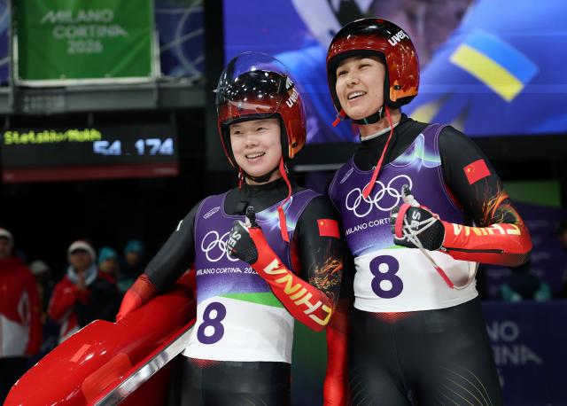 (260211) -- CORTINA D'AMPEZZO, Feb. 11, 2026 (Xinhua) -- Zhao Jiaying (L)/Gulijienaiti Adikeyoumu of China react after the luge women's doubles run 2 at the Milan-Cortina 2026 Olympic Winter Games in Cortina, Italy, Feb. 11, 2026. (Xinhua/Ding Xu)