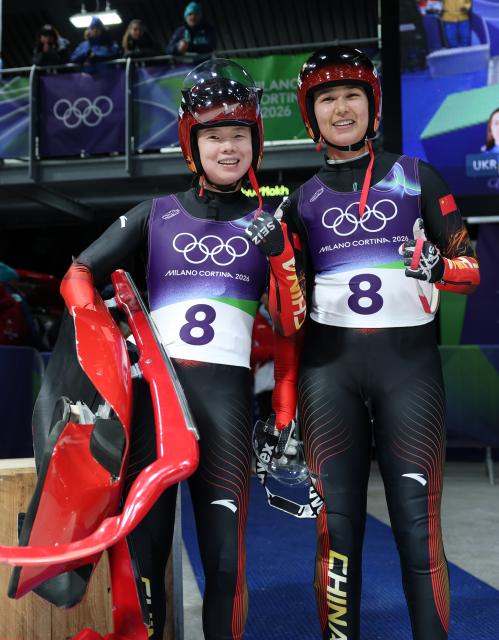 (260211) -- CORTINA D'AMPEZZO, Feb. 11, 2026 (Xinhua) -- Zhao Jiaying (L)/Gulijienaiti Adikeyoumu of China react after the luge women's doubles run 2 at the Milan-Cortina 2026 Olympic Winter Games in Cortina, Italy, Feb. 11, 2026. (Xinhua/Ding Xu)