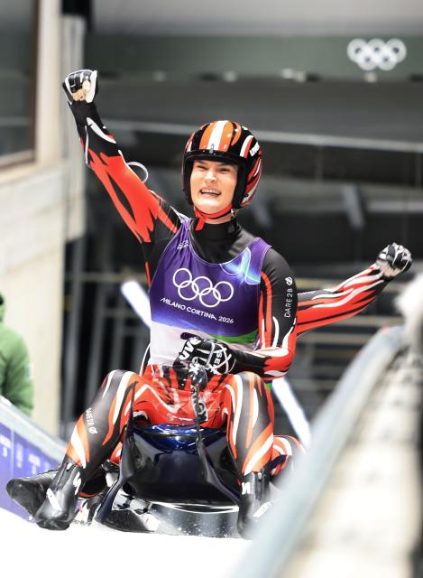(260211) -- CORTINA D'AMPEZZO, Feb. 11, 2026 (Xinhua) -- Selina Egle/Lara Michael Kipp of Austria celebrate after the luge women's doubles match at the Milan-Cortina 2026 Olympic Winter Games in Cortina, Italy, Feb. 11, 2026. (Xinhua/Ding Xu)