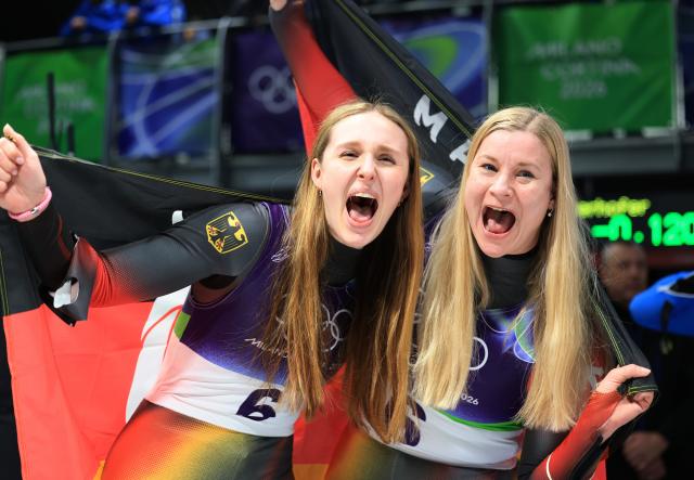 (260211) -- CORTINA D'AMPEZZO, Feb. 11, 2026 (Xinhua) -- Magdalena Matschina (L)/Dajana Eitberger of Germany celebrate after the luge women's doubles run 1 at the Milan-Cortina 2026 Olympic Winter Games in Cortina, Italy, Feb. 11, 2026. (Xinhua/Ding Xu)