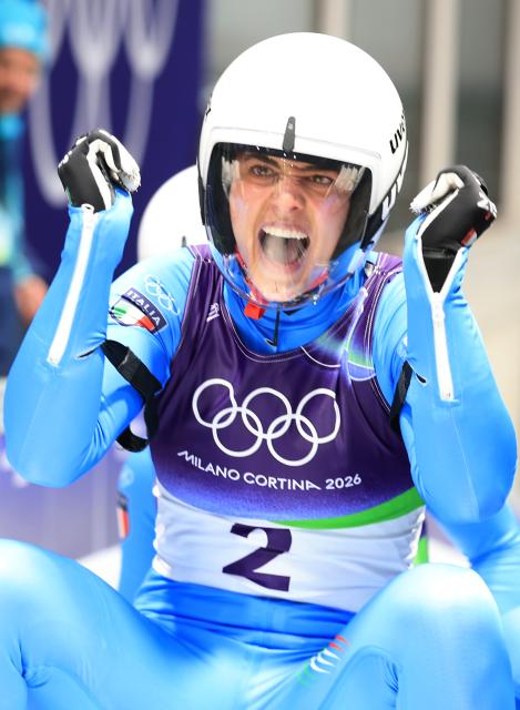 (260211) -- CORTINA D'AMPEZZO, Feb. 11, 2026 (Xinhua) -- Andrea Voetter/Marion Oberhofer of Italy celebrate after the luge women's doubles run 2 at the Milan-Cortina 2026 Olympic Winter Games in Cortina, Italy, Feb. 11, 2026. (Xinhua/Ding Xu)