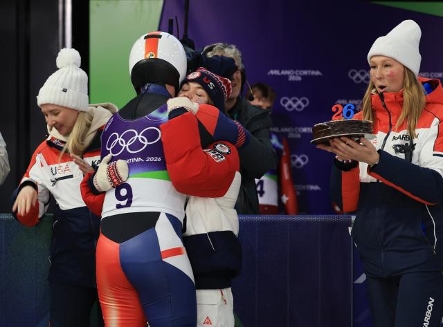 (260212) -- CORTINA D'AMPEZZO, Feb. 12, 2026 (Xinhua) -- Members of the team USA celebrate birthday for a player after of the luge men's doubles match at the Milan-Cortina 2026 Olympic Winter Games in Cortina, Italy, Feb. 11, 2026. (Xinhua/Ding Xu)