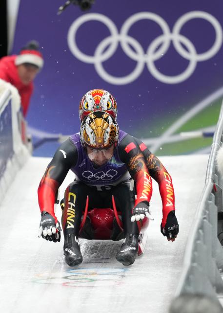 (260212) -- CORTINA D'AMPEZZO, Feb. 12, 2026 (Xinhua) -- Jubayi Saikeyi (front)/Hou Shuo of China compete during the luge men's doubles run 1 at the Milan-Cortina 2026 Olympic Winter Games in Cortina, Italy, Feb. 11, 2026. (Xinhua/Li Gang)
