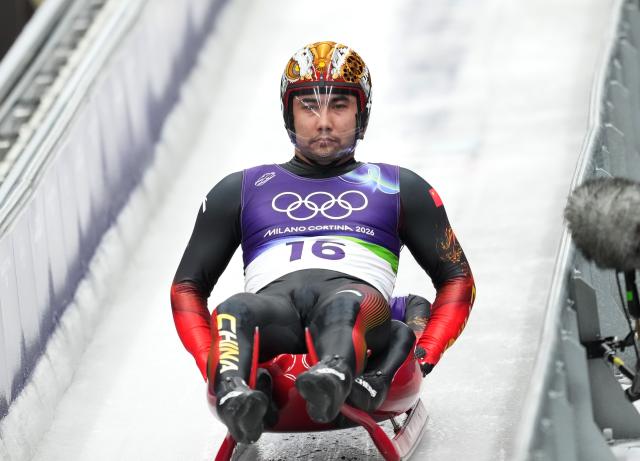 (260212) -- CORTINA D'AMPEZZO, Feb. 12, 2026 (Xinhua) -- Jubayi Saikeyi (front)/Hou Shuo of China compete during the luge men's doubles run 1 at the Milan-Cortina 2026 Olympic Winter Games in Cortina, Italy, Feb. 11, 2026. (Xinhua/Li Gang)
