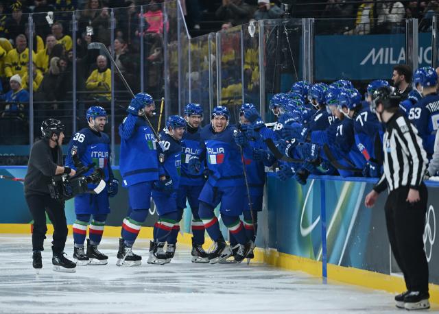 (260212) -- MILAN, Feb. 12, 2026 (Xinhua) -- Players of Italy celebrate a goal during the ice hockey men's preliminary round group B match between Italy and Sweden at the Milan-Cortina 2026 Olympic Winter Games in Milan, Italy, Feb. 11, 2026. (Xinhua/Zhang Haofu)