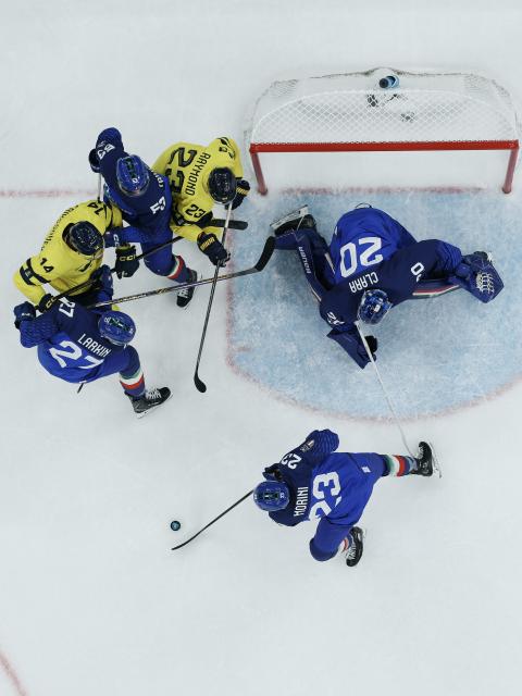 (260212) -- MILAN, Feb. 12, 2026 (Xinhua) -- Players of both teams compete during the ice hockey men's preliminary round group B match between Italy and Sweden at the Milan-Cortina 2026 Olympic Winter Games in Milan, Italy, Feb. 11, 2026. (Xinhua/Zhang Haofu)