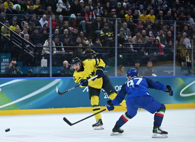 (260212) -- MILAN, Feb. 12, 2026 (Xinhua) -- Mika Zibanejad (L) of Sweden shoots during the ice hockey men's preliminary round group B match between Italy and Sweden at the Milan-Cortina 2026 Olympic Winter Games in Milan, Italy, Feb. 11, 2026. (Xinhua/Zhang Haofu)
