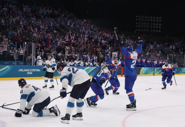 (260212) -- MILAN, Feb. 12, 2026 (Xinhua) -- Slovakia's Adam Ruzicka (front R) celebrates a goal with teammates during the ice hockey men's preliminary round group B match between Finland and Slovakia at the Milan-Cortina 2026 Olympic Winter Games in Milan, Italy, Feb. 11, 2026. (Xinhua/Wang Kaiyan)