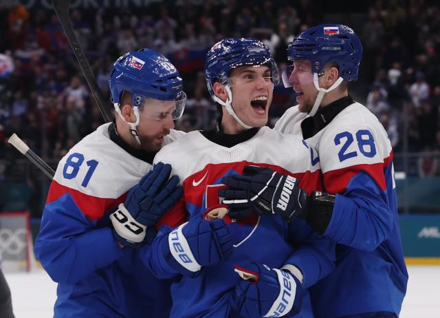 (260212) -- MILAN, Feb. 12, 2026 (Xinhua) -- Slovakia's Adam Ruzicka (C) celebrates a goal with teammates during the ice hockey men's preliminary round group B match between Finland and Slovakia at the Milan-Cortina 2026 Olympic Winter Games in Milan, Italy, Feb. 11, 2026. (Xinhua/Wang Kaiyan)