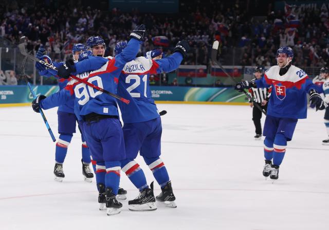 (260212) -- MILAN, Feb. 12, 2026 (Xinhua) -- Players of Slovakia celebrate a goal during the ice hockey men's preliminary round group B match between Finland and Slovakia at the Milan-Cortina 2026 Olympic Winter Games in Milan, Italy, Feb. 11, 2026. (Xinhua/Wang Kaiyan)