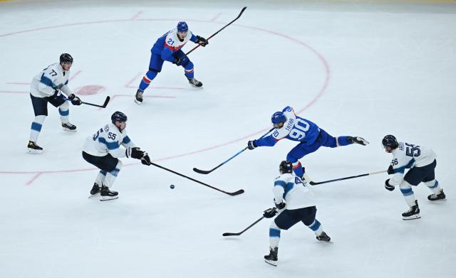 (260212) -- MILAN, Feb. 12, 2026 (Xinhua) -- Tomas Tatar (2nd R) of Slovakia scores during the ice hockey men's preliminary round group B match between Finland and Slovakia at the Milan-Cortina 2026 Olympic Winter Games in Milan, Italy, Feb. 11, 2026. (Xinhua/Zhang Haofu)