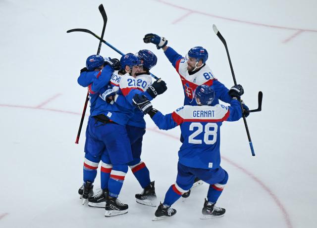 (260212) -- MILAN, Feb. 12, 2026 (Xinhua) -- Players of Slovakia celebrate a goal during the ice hockey men's preliminary round group B match between Finland and Slovakia at the Milan-Cortina 2026 Olympic Winter Games in Milan, Italy, Feb. 11, 2026. (Xinhua/Zhang Haofu)