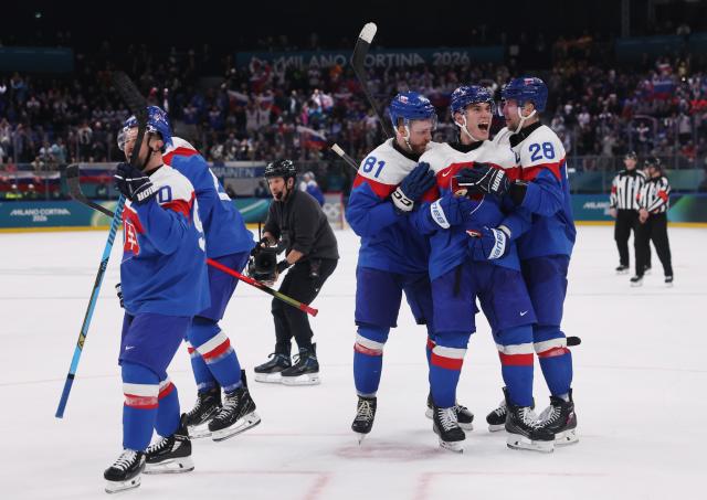 (260212) -- MILAN, Feb. 12, 2026 (Xinhua) -- Players of Slovakia celebrate a goal during the ice hockey men's preliminary round group B match between Finland and Slovakia at the Milan-Cortina 2026 Olympic Winter Games in Milan, Italy, Feb. 11, 2026. (Xinhua/Wang Kaiyan)