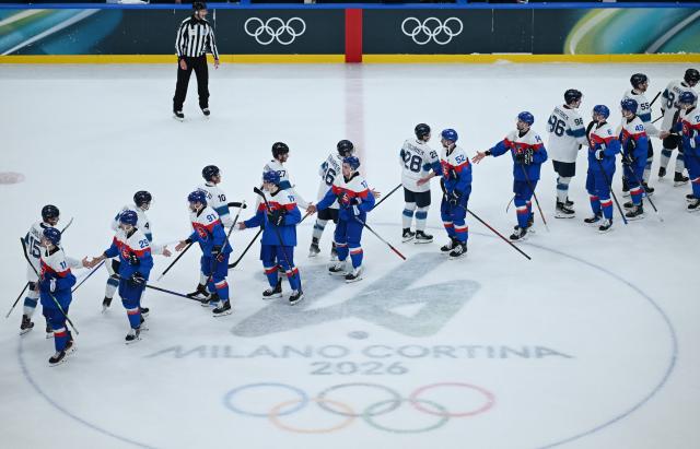 (260212) -- MILAN, Feb. 12, 2026 (Xinhua) -- Players of both teams greet after the ice hockey men's preliminary round group B match between Finland and Slovakia at the Milan-Cortina 2026 Olympic Winter Games in Milan, Italy, Feb. 11, 2026. (Xinhua/Zhang Haofu)