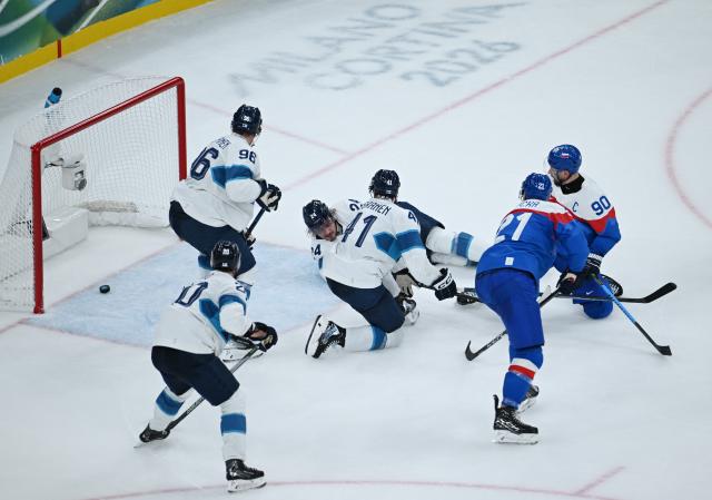 (260212) -- MILAN, Feb. 12, 2026 (Xinhua) -- Slovakia's Adam Ruzicka (2nd R) scores during the ice hockey men's preliminary round group B match between Finland and Slovakia at the Milan-Cortina 2026 Olympic Winter Games in Milan, Italy, Feb. 11, 2026. (Xinhua/Zhang Haofu)