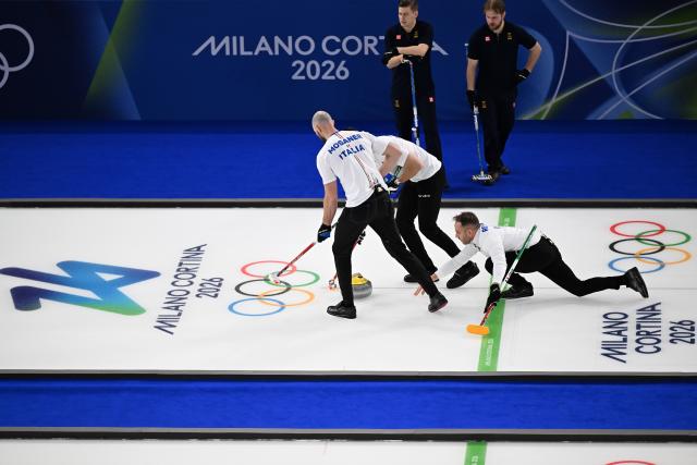 (260212) -- CORTINA D'AMPEZZO, Feb. 12, 2026 (Xinhua) -- Amos Mosaner (1st, L) of Italy competes during the curling men round robin session 1 match between Sweden and Italy at the 2026 Milan-Cortina Winter Olympics in Cortina D'Ampezzo, Italy, Feb. 11, 2026. (Xinhua/Lian Yi)