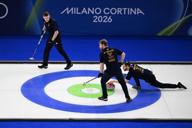 (260212) -- CORTINA D'AMPEZZO, Feb. 12, 2026 (Xinhua) -- Rasmus Wrana (C) of Sweden and Oskar Eriksson (R) of Sweden compete during the curling men round robin session 1 match between Sweden and Italy at the 2026 Milan-Cortina Winter Olympics in Cortina D'Ampezzo, Italy, Feb. 11, 2026. (Xinhua/Lian Yi)
