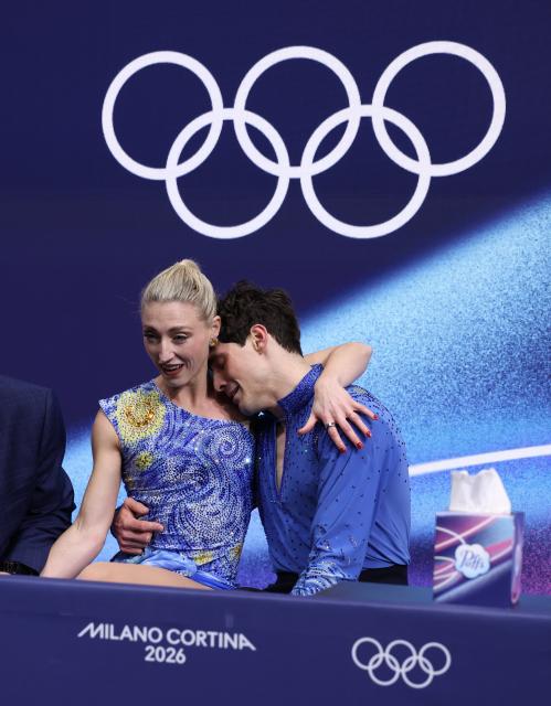 (260212) -- MILAN, Feb. 12, 2026 (Xinhua) -- Piper Gilles and Paul Poirier of Canada react as they wait for the scores during the free dance competition of figure skating ice dance at the Milan-Cortina 2026 Olympic Winter Games in Milan, Italy, Feb. 11, 2026. (Xinhua/Chen Yichen)